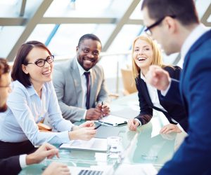 Business people laughing together at meeting