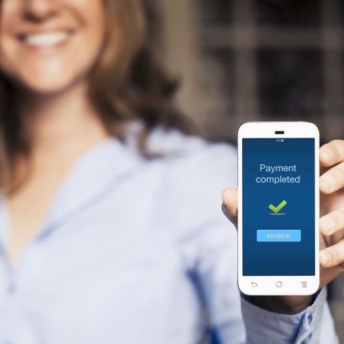 Payment completed message. Girl showing her mobile phone.